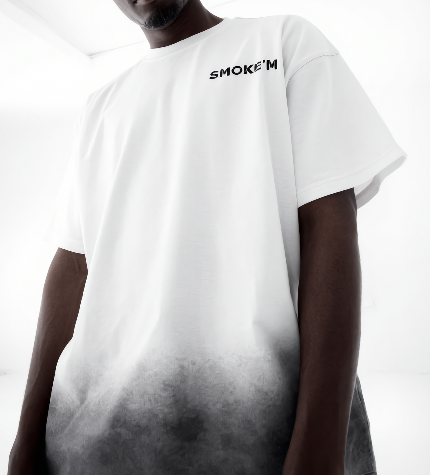 Person wearing a white t-shirt with 'SMOKEM' text on a gradient background