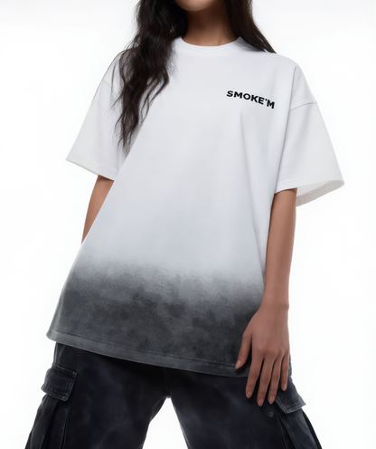 Person wearing a white t-shirt with gradient design and 'SMOKE'EM' text.