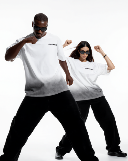 Two people wearing matching white t-shirts and black pants on a white background
